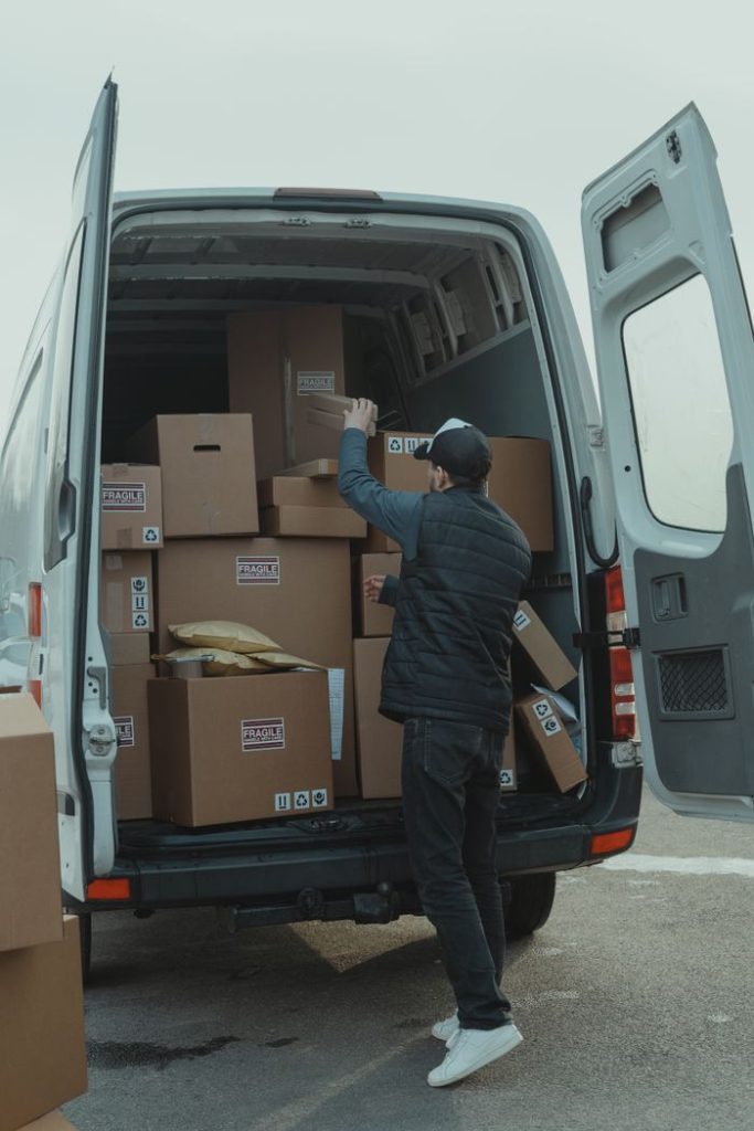 The Art of Drawing Readers In: Your attractive post title goes here A courier organizing boxes in a delivery van for shipment on a cloudy day.